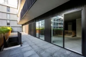 Moderne buitenruimte met glazen schuifdeuren aan de Oostenburgermiddenstraat in Amsterdam.