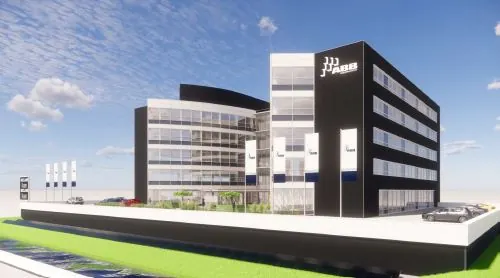 Modern kantoorgebouw aan het Stationspark met glazen gevel en zwarte accenten onder een blauwe lucht.