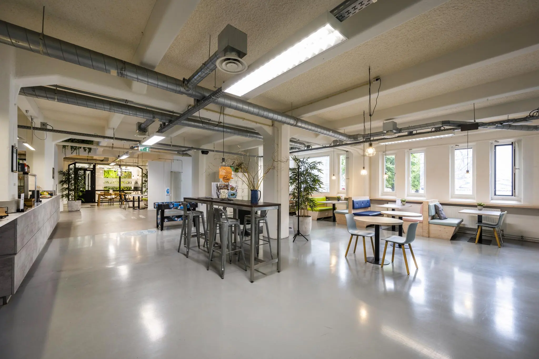 Moderne en open kantoorruimte aan de Van Diemenstraat met zitgedeeltes, hoge tafels en veel daglicht.