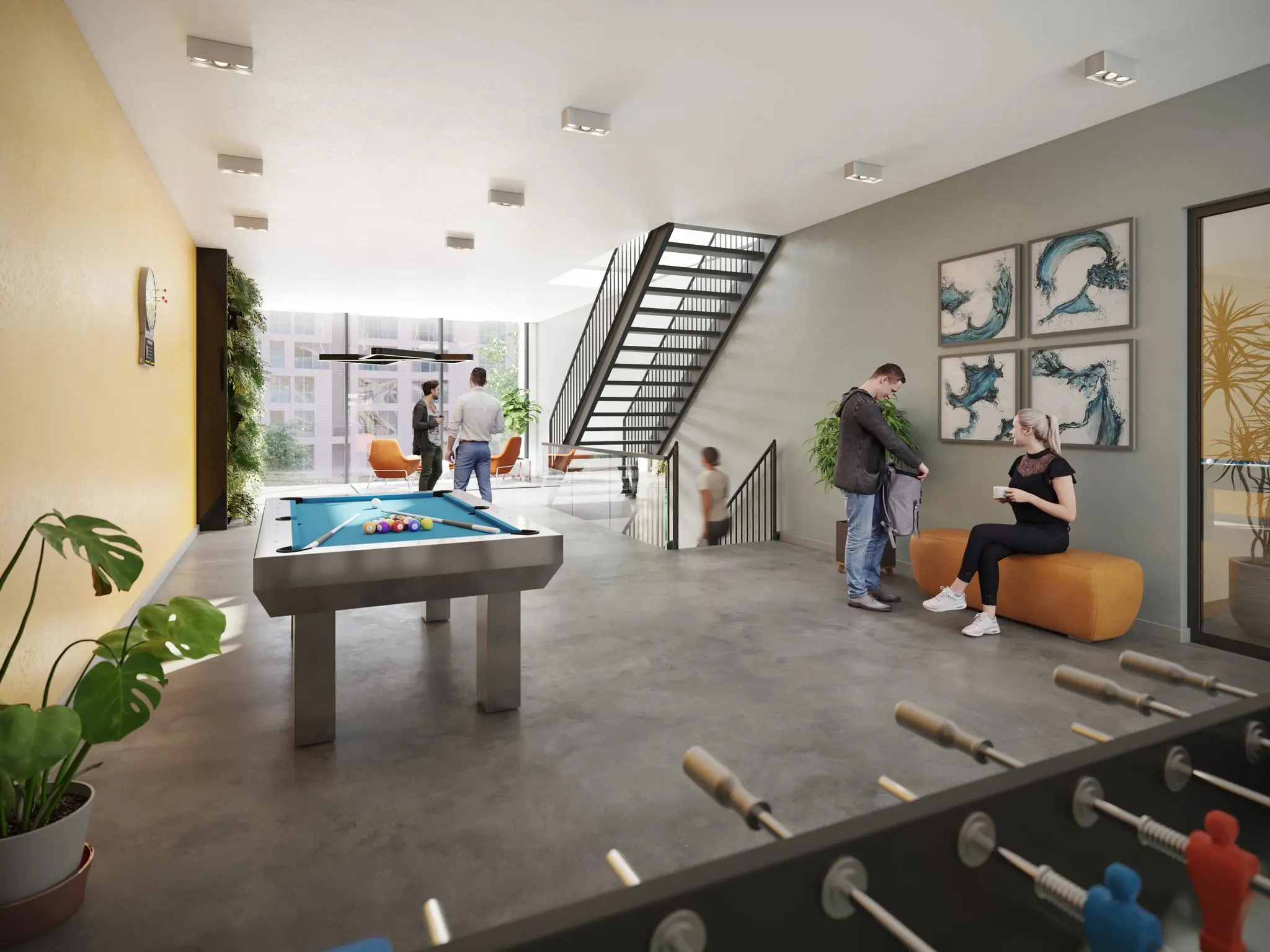 Moderne gemeenschappelijke ruimte aan de Treubstraat met een biljarttafel, tafelvoetbal en zithoeken waar mensen ontspannen.