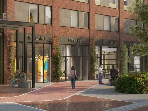 Straatbeeld van de Treubstraat met mensen voor een modern bedrijfsverzamelgebouw met Flex Units 6, 7 en 8.