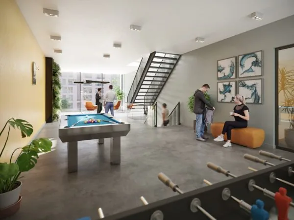 Moderne gemeenschappelijke ruimte in een wooncomplex aan de Treubstraat met een pooltafel, tafelvoetbalspel en zitgelegenheid.