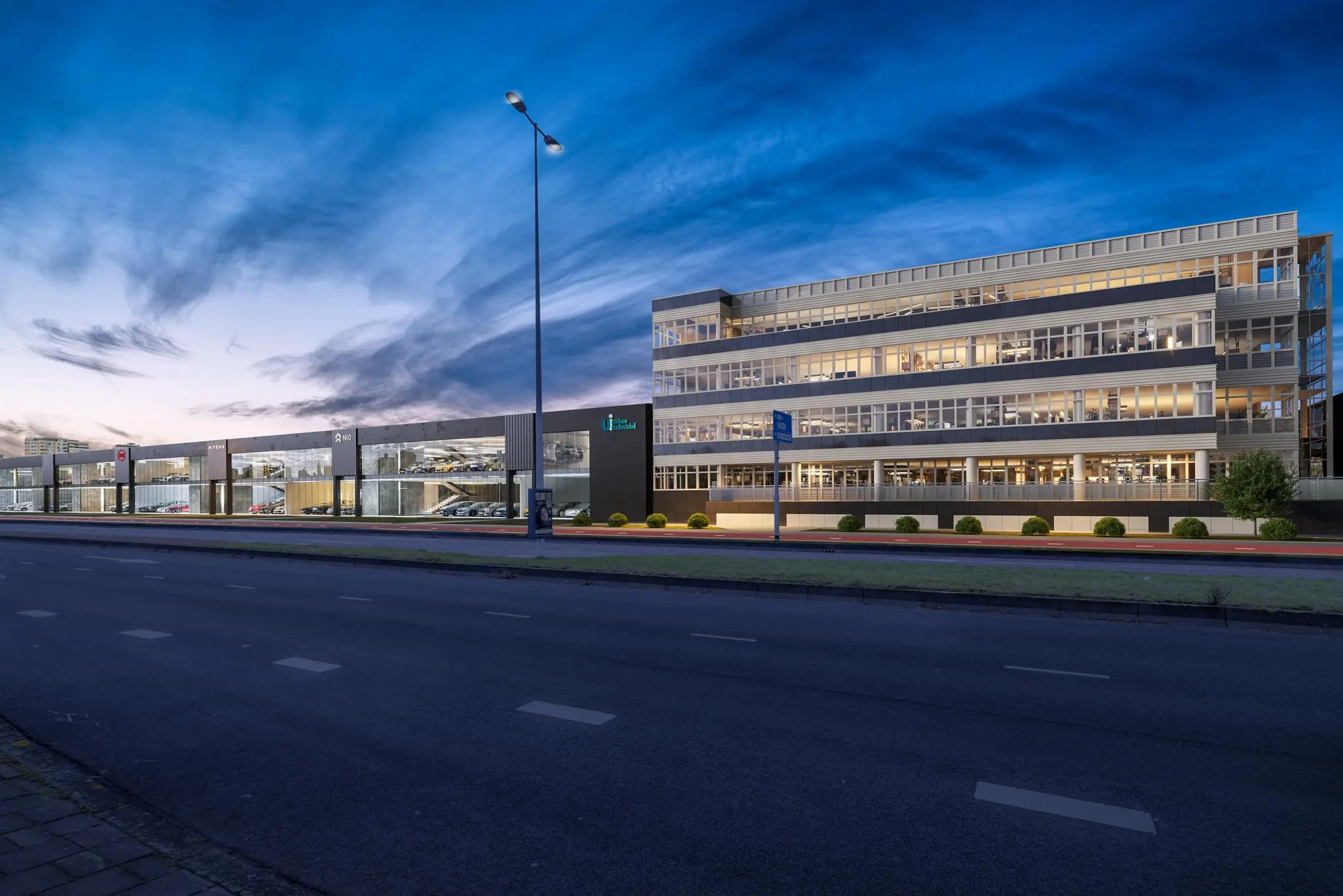 Modern kantoorgebouw en autoshowroom aan de Lemelerbergweg in Amsterdam bij schemering.