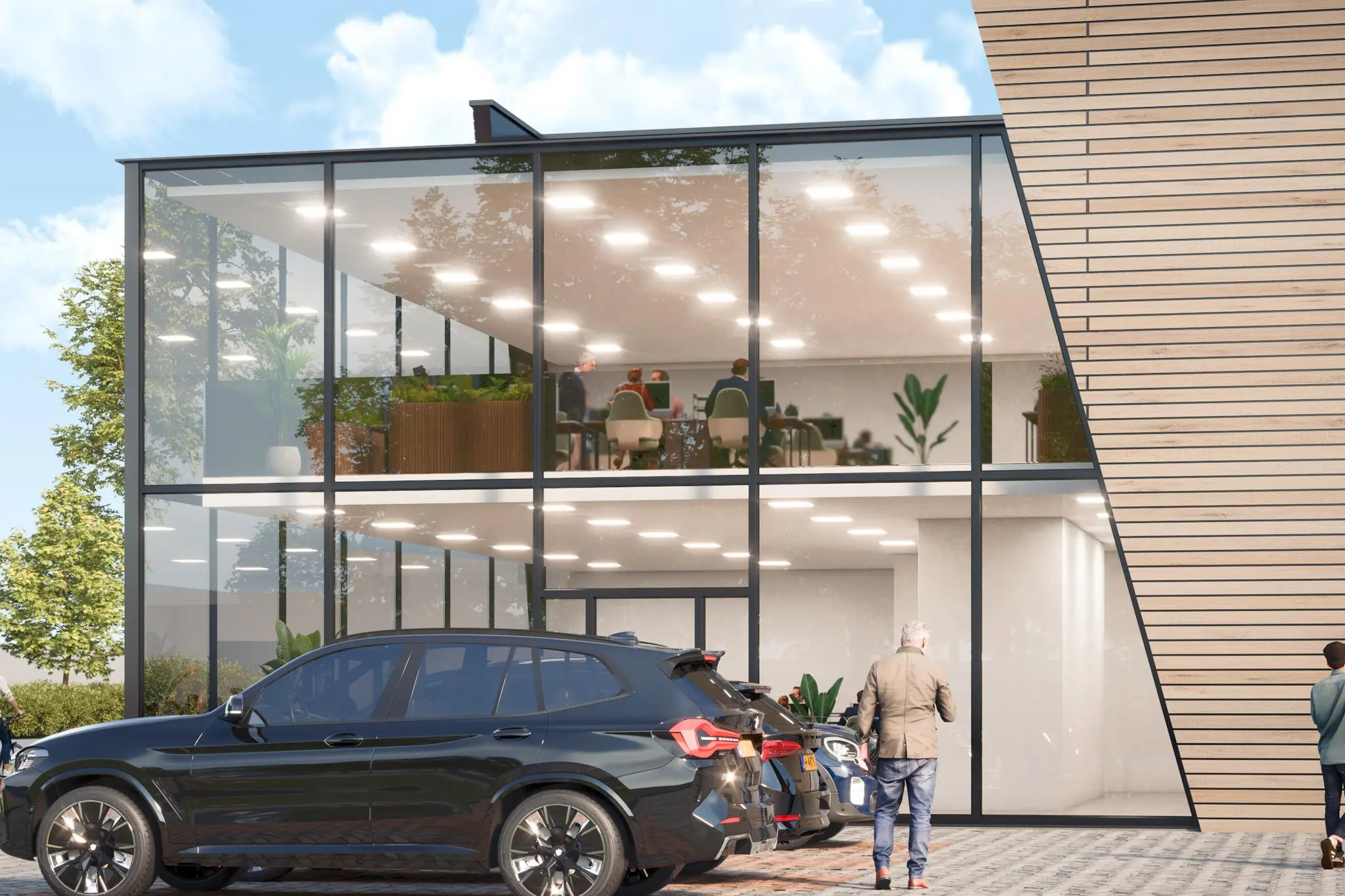 Modern kantoorpand aan de Nijverheidsweg met glazen gevel, geparkeerde auto's en zicht op kantoorruimtes binnen.