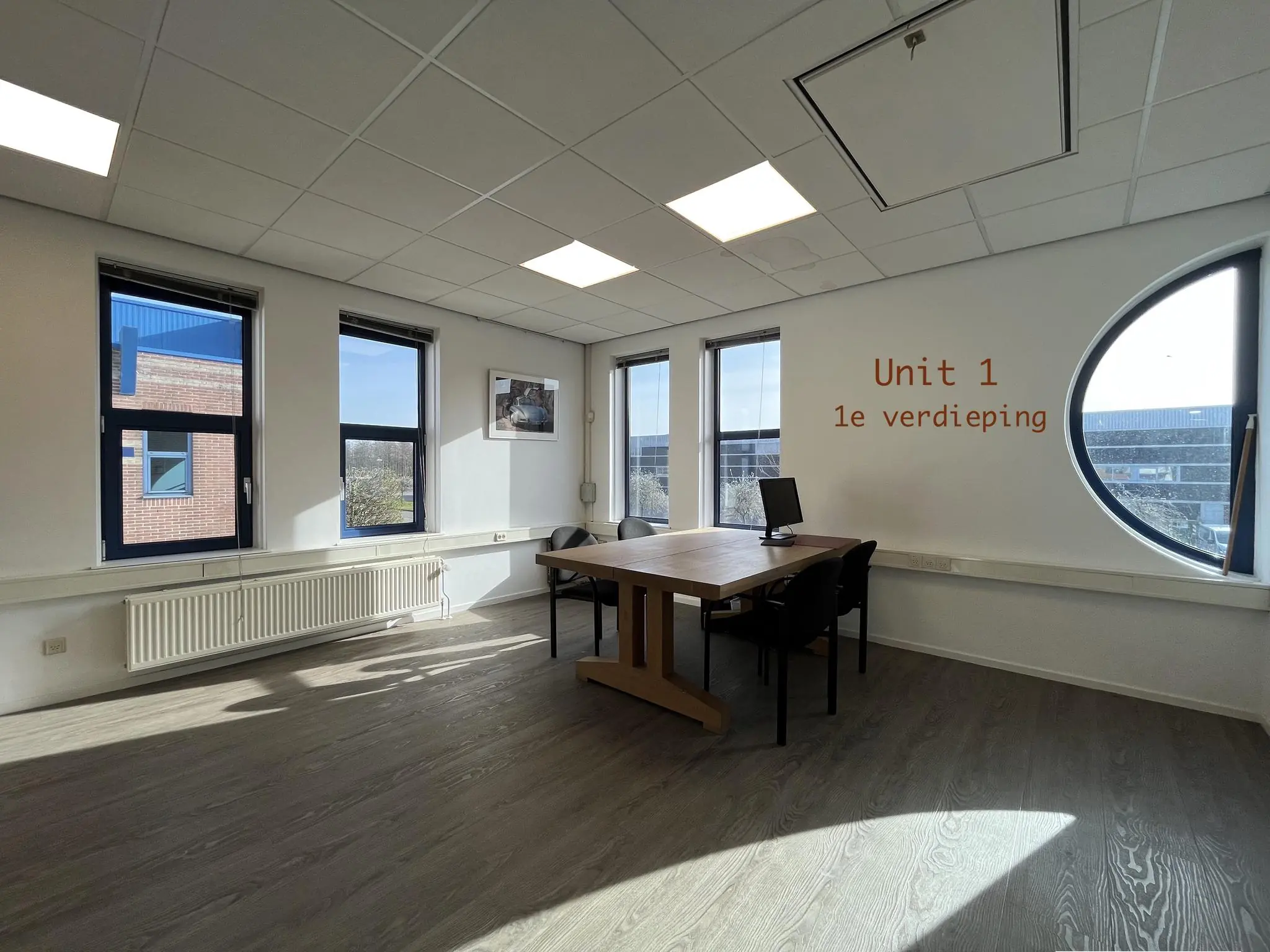 Lichte kantoorruimte op de eerste verdieping van Unit 1 in het gebouw Bergveste, met een tafel, stoelen en een computer.