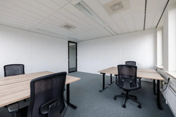Een moderne, lege kantoorruimte met vier bureaus en stoelen bij Stadsring 201 in Amersfoort.