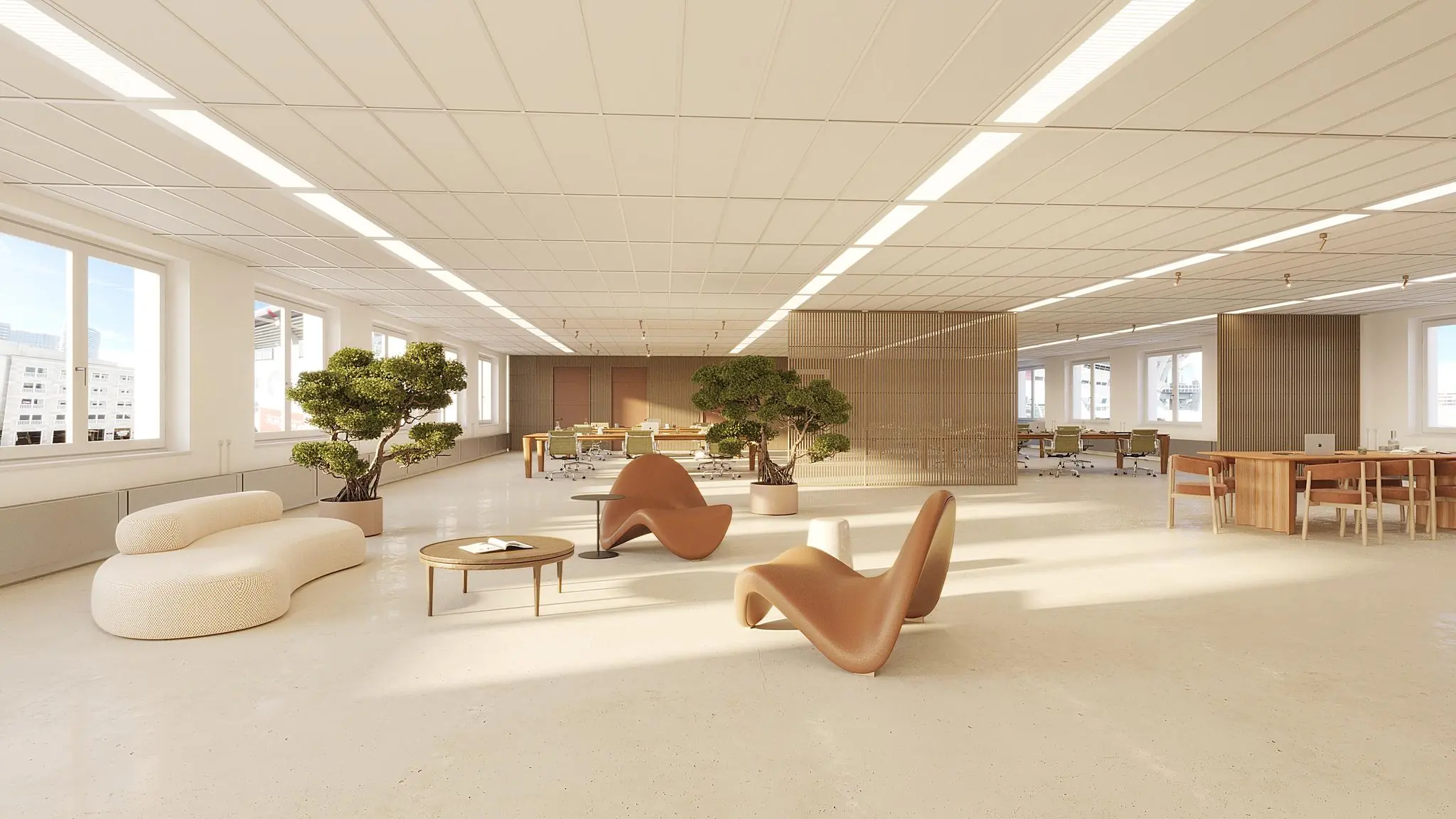 Licht en ruim kantoorinterieur aan de Johan Cruijff Boulevard met moderne meubels, grote ramen en groene planten.