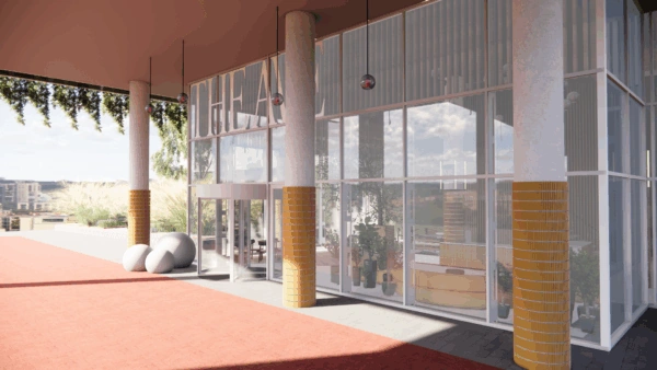 Moderne glazen entree van het Scorpius Theater met hoge zuilen en planten binnenin.
