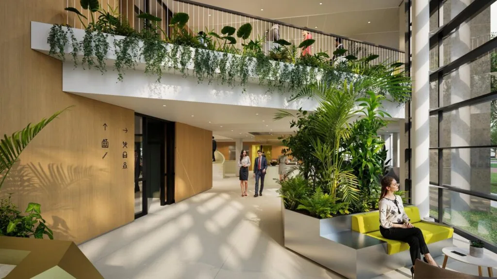 Moderne en groene entreehal van een kantoorgebouw met veel planten, zitgelegenheid en natuurlijk licht.