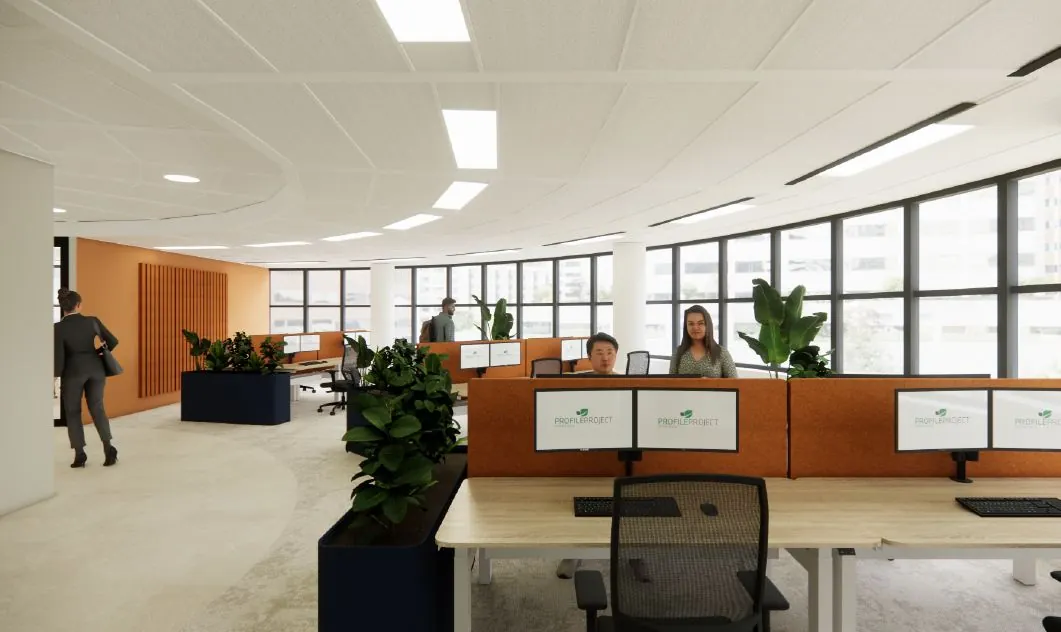 Een modern en licht kantoor met werkplekken gescheiden door planten en werknemers achter computers.