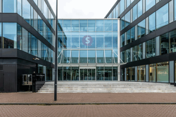Modern office building entrance at Pedro de Medinalaan with glass facade and Steigereiland Offices signage.