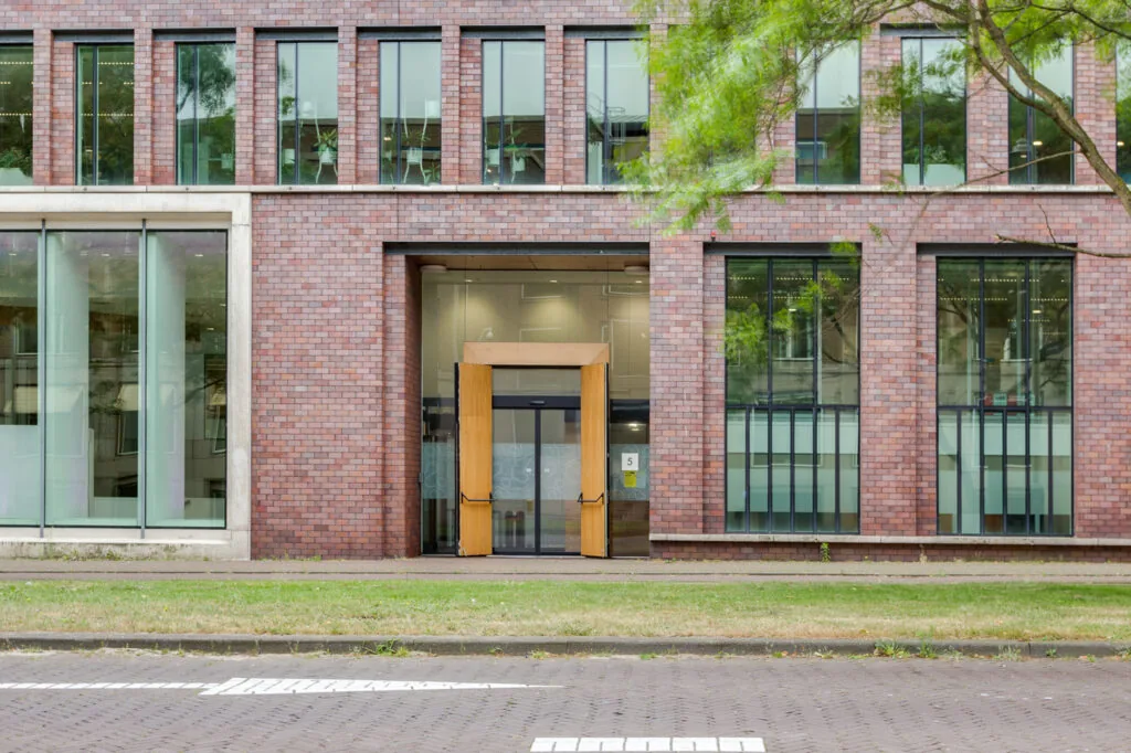 Front entrance of a modern brick office building on Carel van Bylandtlaan.