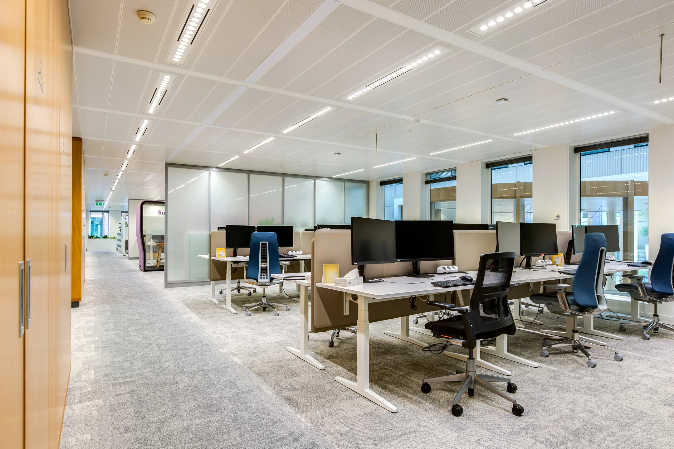 Modern open-plan office space on Carel van Bylandtlaan with multiple workstations and ergonomic chairs.