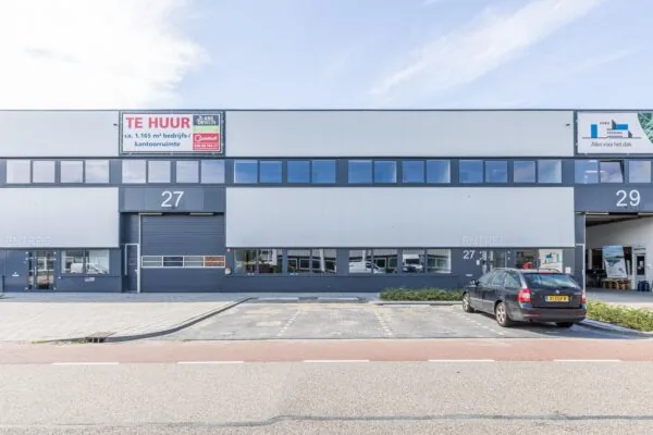 Modern commercial building at Zonnebaan with office space for rent and parking in front.