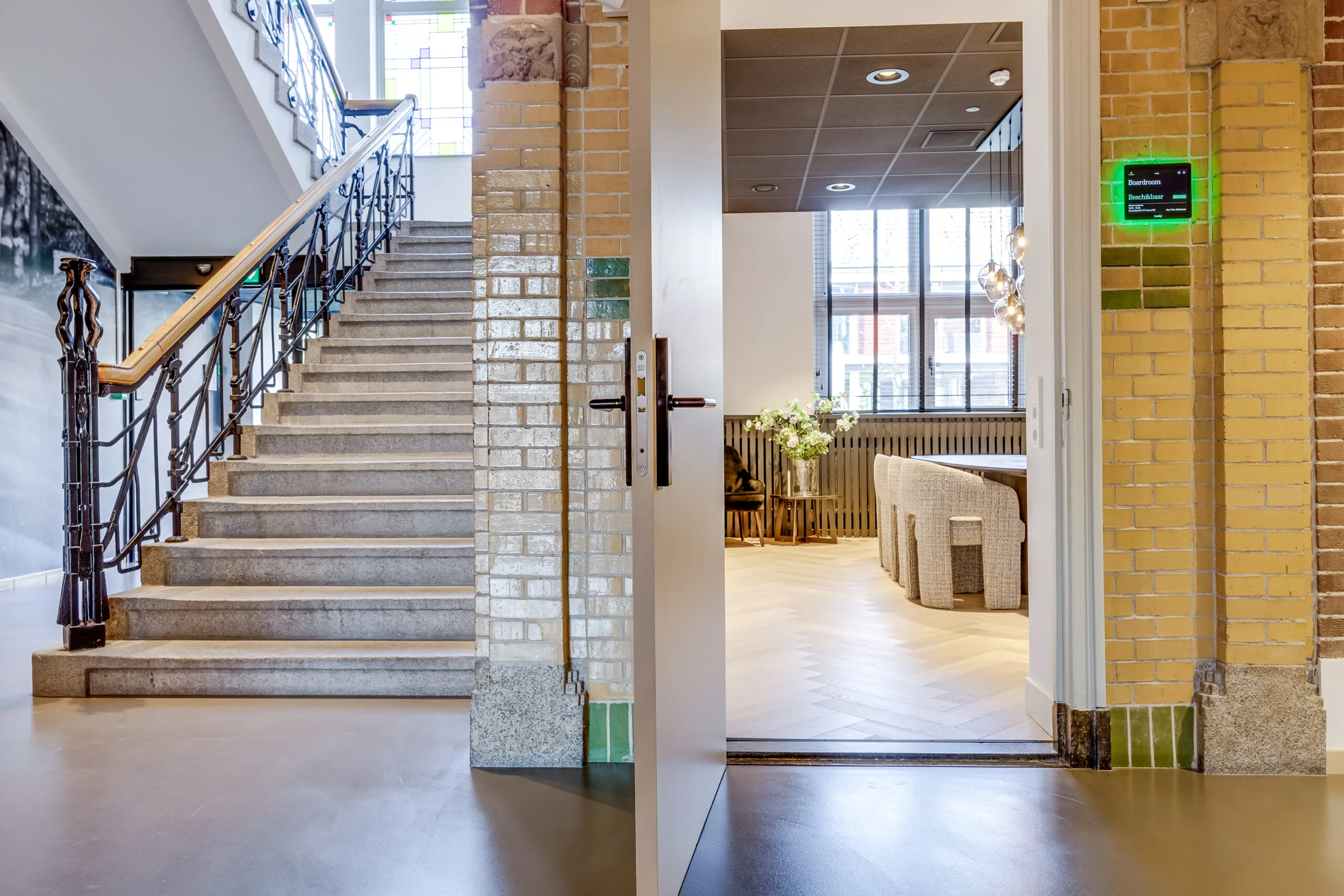 Entrance to a modern boardroom next to a staircase in the Lage Naarderweg building.