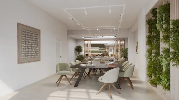 Moderne vergaderruimte aan de Baarsjesweg met een lange houten tafel, mintgroene stoelen en een groene plantenwand.