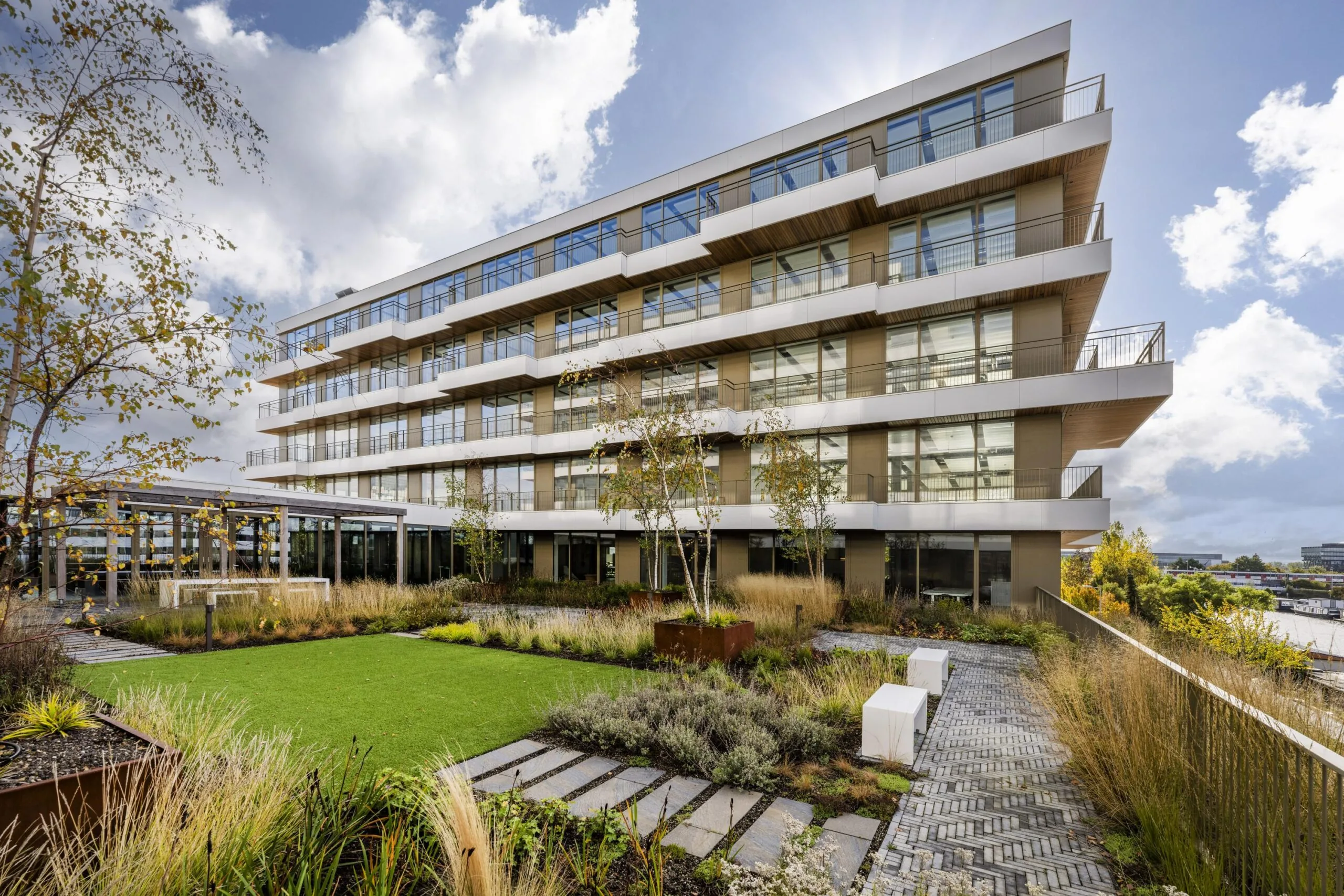 Modern gebouw met een groene daktuin op de Willem Fenengastraat onder een bewolkte hemel.