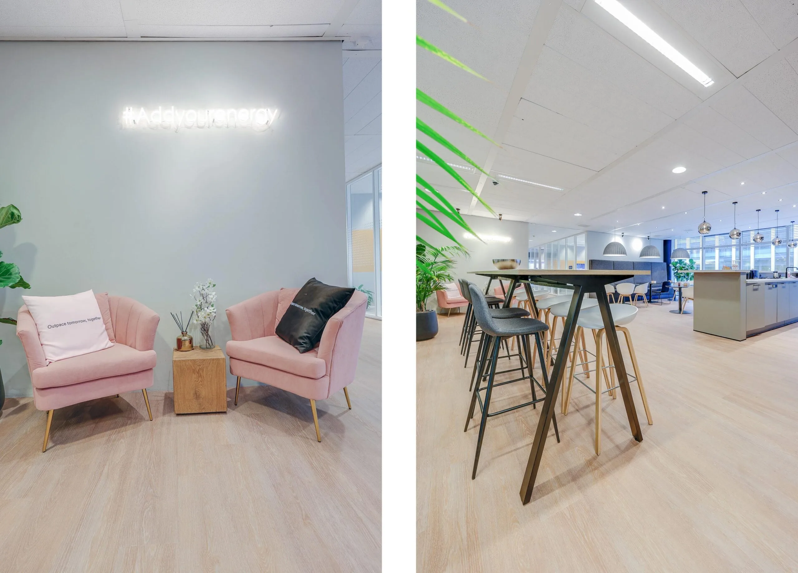 Een moderne kantoorruimte met roze stoelen, een neonbord met "#Addyourenergy", hoge tafels en planten.