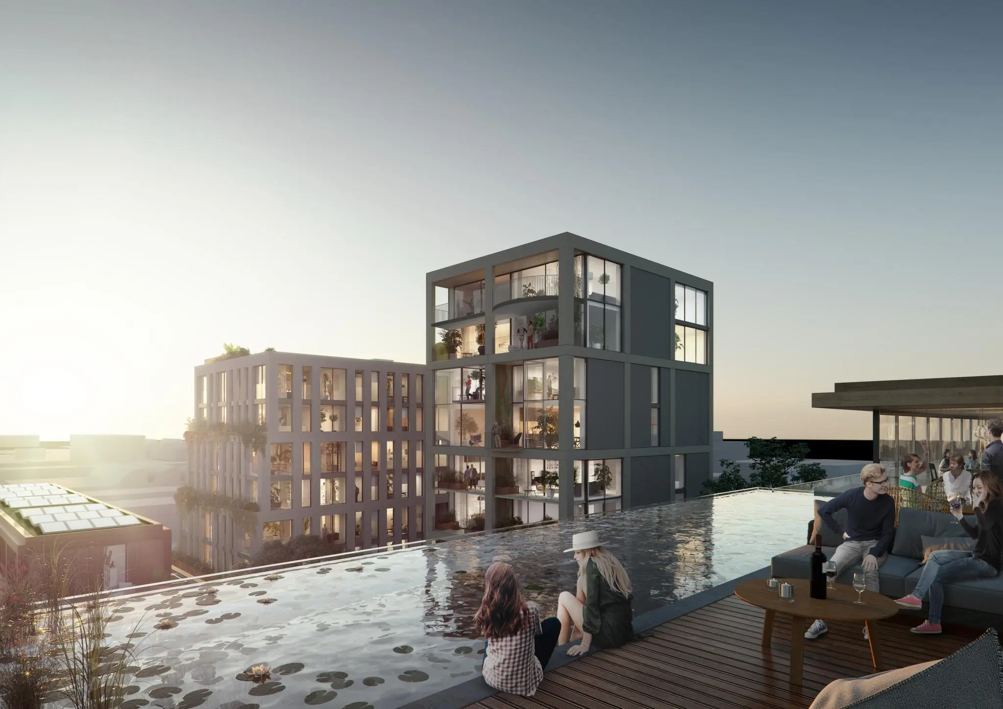 Moderne appartementcomplexen aan de Papaverweg met dakterras, vijver en mensen die ontspannen bij zonsondergang.