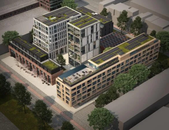 Luchtfoto van moderne appartementencomplexen aan de Papaverweg met zonnepanelen en groene daken.