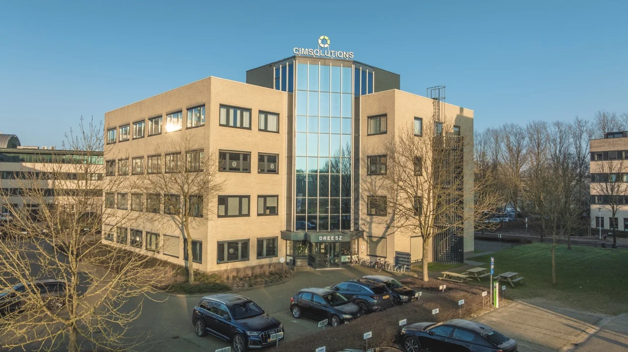 Vooraanzicht van het kantoorpand van CIMsolutions en Dreesz op een zonnige dag.