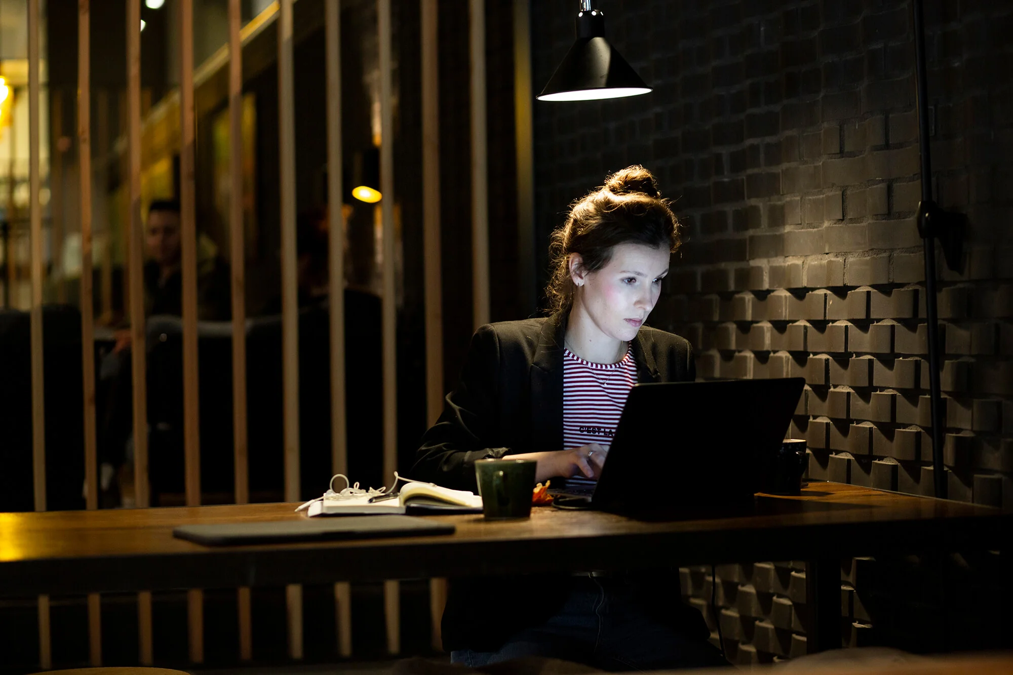 Vrouw werkt geconcentreerd op een laptop in een modern ingerichte kantoorruimte aan het Kennemerplein in Haarlem.