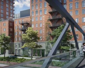 Kantoorruimte aan de Karl Weisbardstraat in Rotterdam met rode bakstenen gevel en buitentrappen, gezien vanaf een voetgangersbrug.