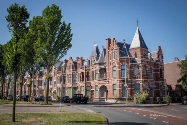 Historic red-brick townhouses with decorative roofs in the Statenkwartier district of The Hague.
