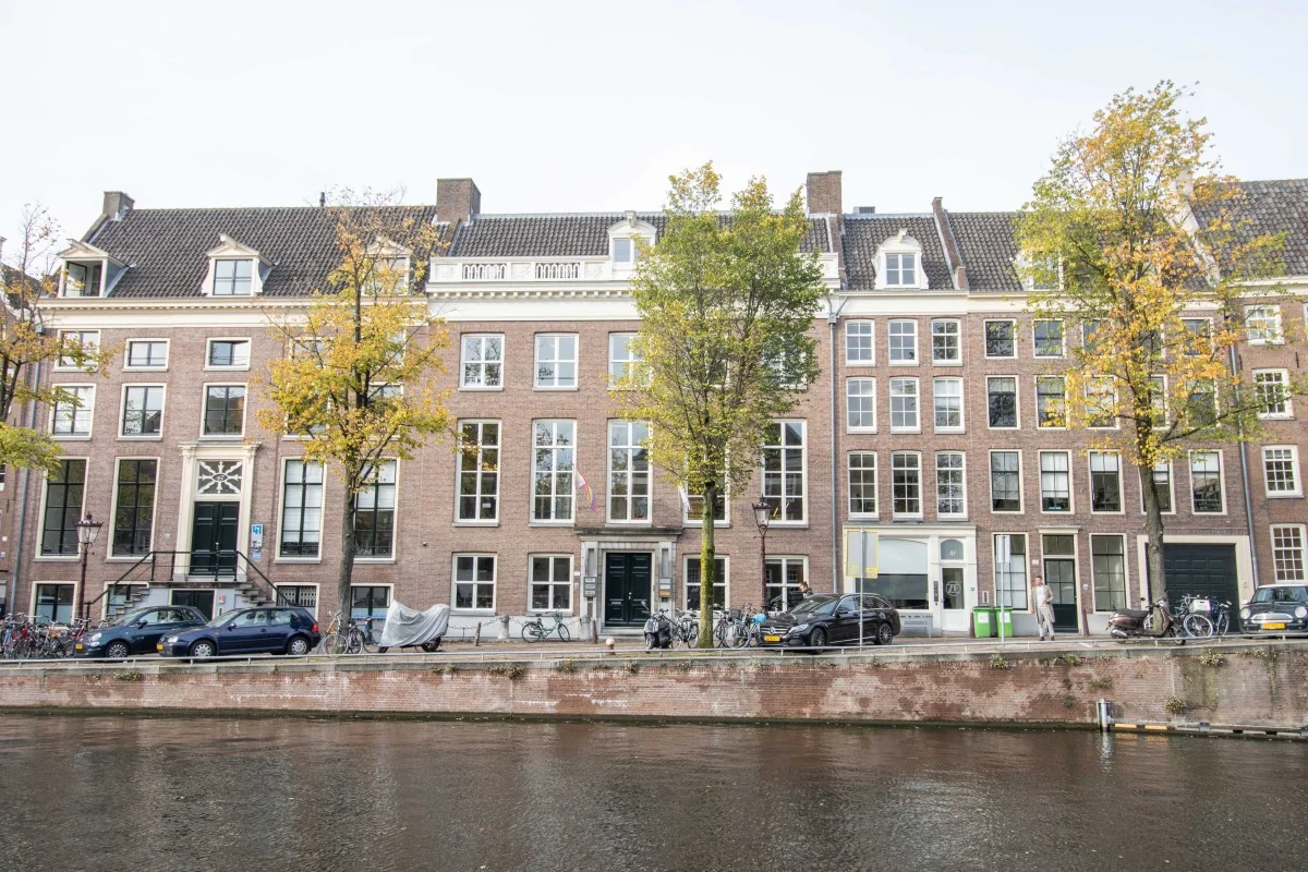 Voorgevel van een karakteristiek kantoorpand aan de Nieuwe Herengracht 18 in Amsterdam, met uitzicht op de gracht.